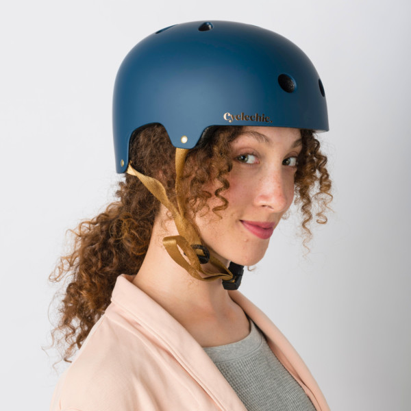 Lady wearing the Cyclechic 'Deco' Ladies Navy Blue Helmet