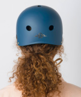 Lady wearing the Cyclechic 'Deco' Ladies Navy Blue Helmet from the back