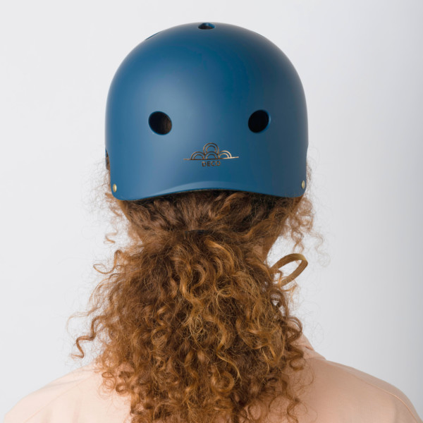 Lady wearing the Cyclechic 'Deco' Ladies Navy Blue Helmet from the back