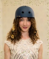 Girl wearing mavy bike helmet with a Christmas feel