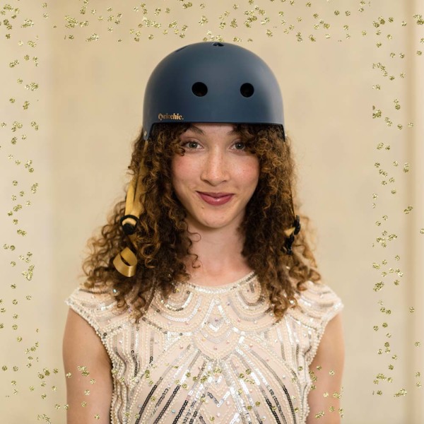 Girl wearing mavy bike helmet with a Christmas feel