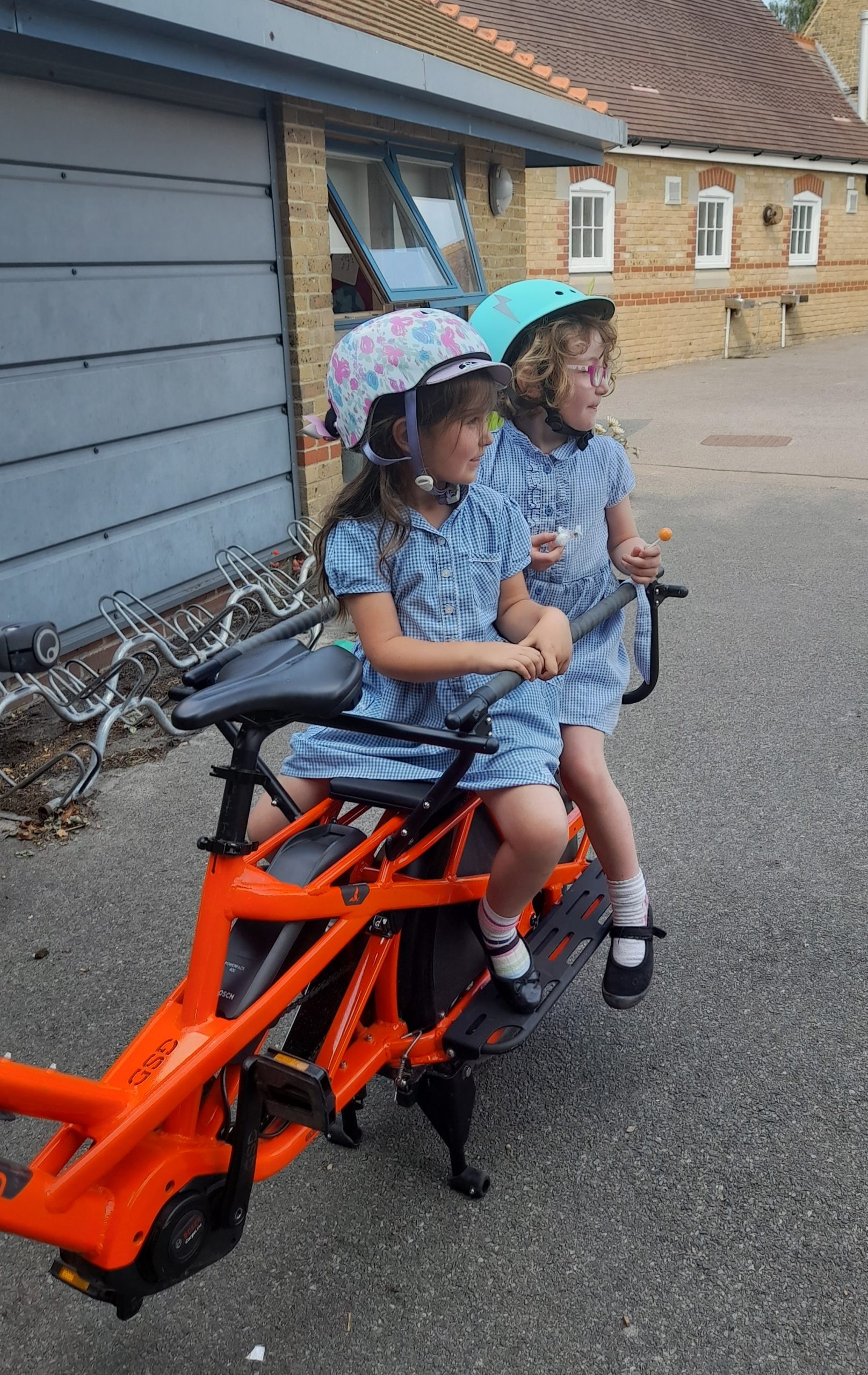 Two school girls on the back of a Tern GSD ecargo bike.