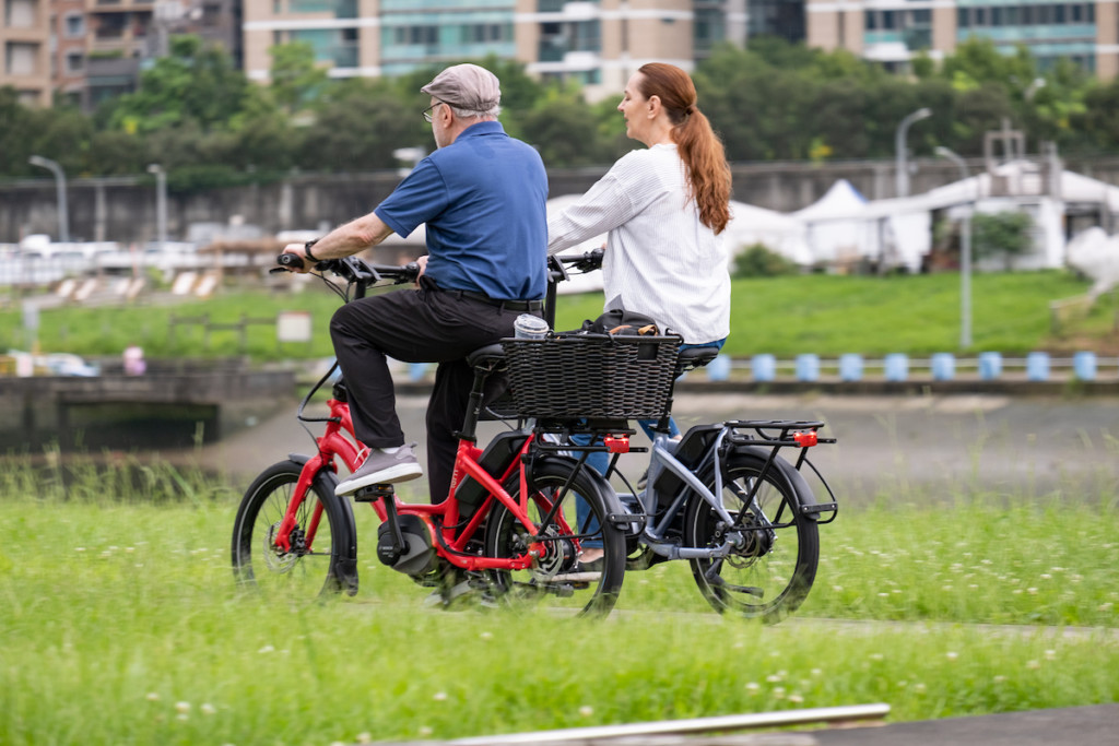 Older couple riding Tern NDB electric bikes. 